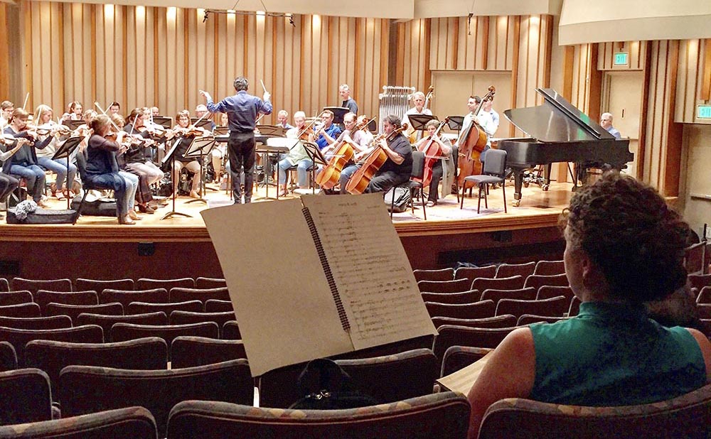 Gibson watches LACO musicians during a reading of her new composition.